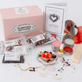 Glamour and Self Love Ritual and Spell Kit displayed on a white background, including a pink box, card, crystals, salts, candles, a small mirror, a spoon, and other ritual items.