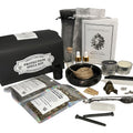 A Protection Spell Kit by Raven and Rogue shown with its black branded box, pouch, booklet, herbs in bags, candles, bowls, tools, and other ritual components arranged on a white background.