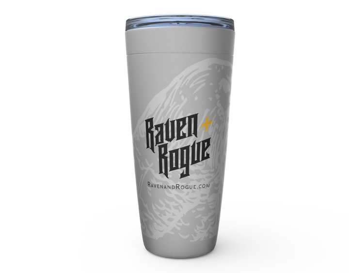 A silver 20 oz tumbler with the Raven and Rogue logo printed on it.